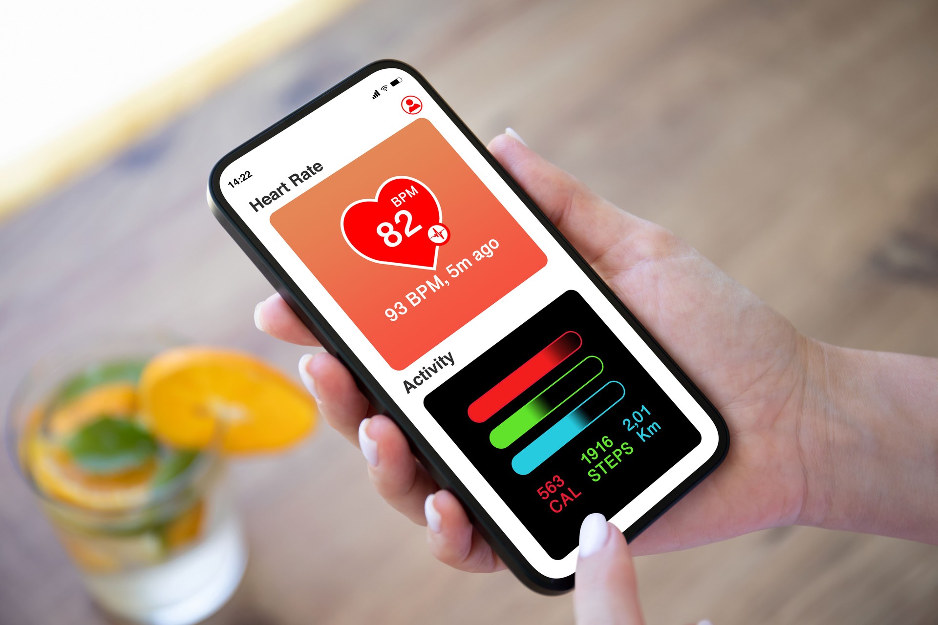 woman hand hold phone with app heart and activity screen